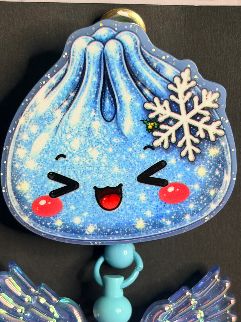 Winter Kawaii Dumpling Badge Reel with Iridescent Angel Wings & Teal Beaded Charm