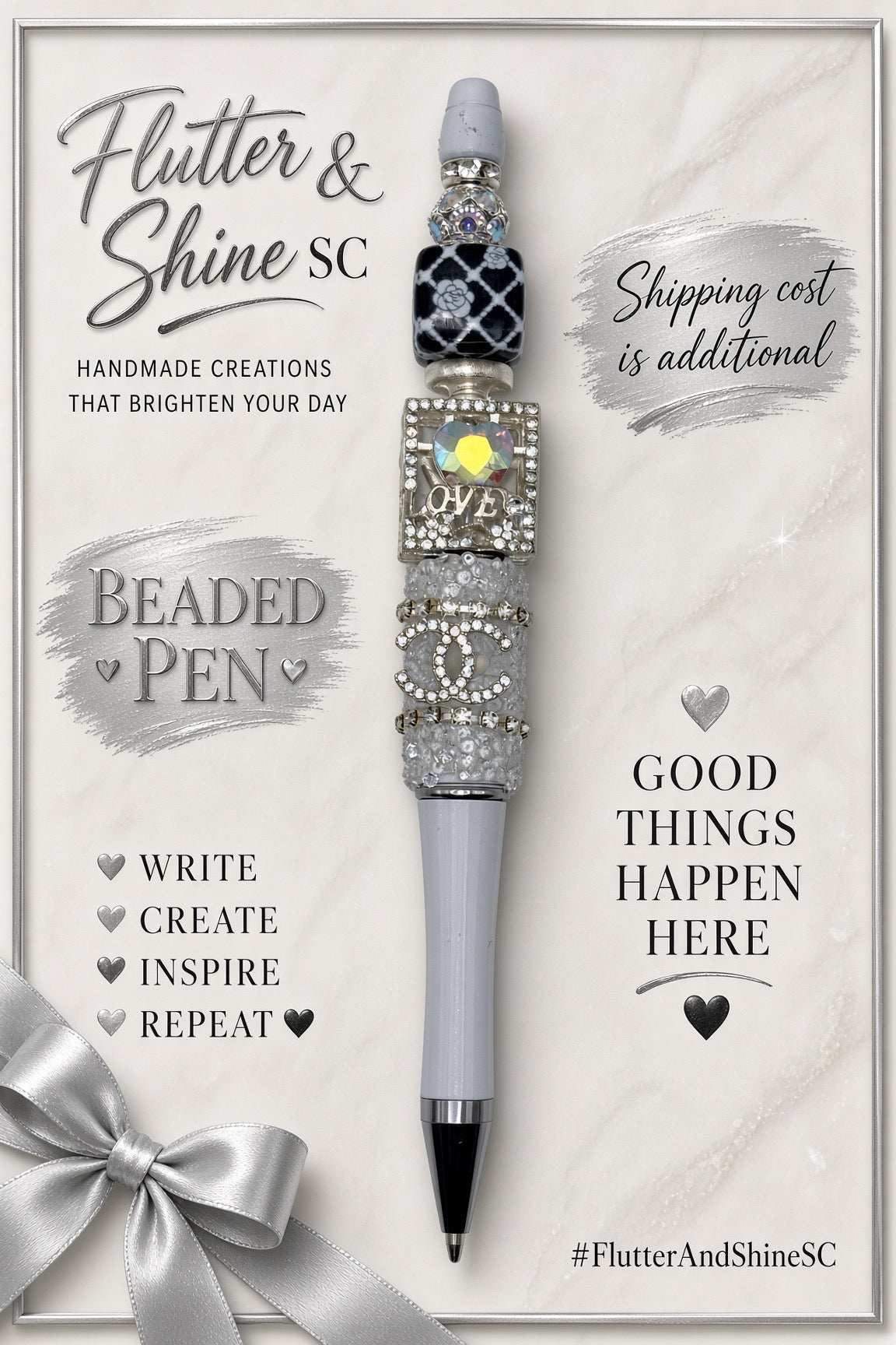 Gray and silver-tone LOVE beaded pen displayed on a Flutter & Shine SC branded background with a decorative silver bow; display props are not included.