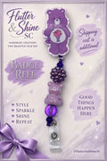 Share Bear themed badge reel in purple and lavender with a milkshake belly design, clustered purple accent, lavender bear-shaped bead, purple bead, and clear snap badge strap.