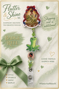 Tiana themed badge reel with framed character topper, large green frog accent, pink Tiana bead, green and pale accent beads, and clear snap strap.