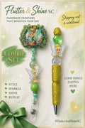 Tinker Bell themed matching set with a green beaded badge reel featuring a framed character topper and a gold-colored sparkling pen with green and clear accent beads.