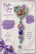 Rapunzel themed badge reel with floral castle and Pascal topper, purple character accents, purple swirled bead, mint-green connectors, and clear snap strap.