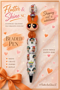 Blossom Themed beaded pen with orange bow character face, orange glitter bead, reflective round bead, white Powerpuff Girls decorated barrel, sparkling accents, and dark pointed tip.