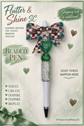 Starbucks Themed beaded pen with brown-and-white checkered coffee bow, green glitter heart bead, translucent green round bead, sparkling silver-toned barrel section, and pale lavender lower barrel.