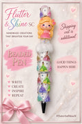 Aurora Themed beaded pen with blonde princess in a pink dress, clear round bead, fluffy-looking white accent, white pastel-princess decorated barrel, sparkling details, and dark pointed tip.