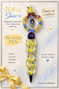 Snow White Themed beaded pen with yellow-and-blue rose heart accent, deep-red bow, oval character detail, dark blue swirled bead, yellow-and-white character barrel, and dark pointed tip.